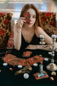 a girl holding a tarot card, behavioral assessment online